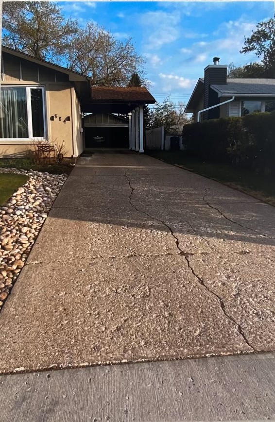 Before: cracked concrete driveway in Edmonton